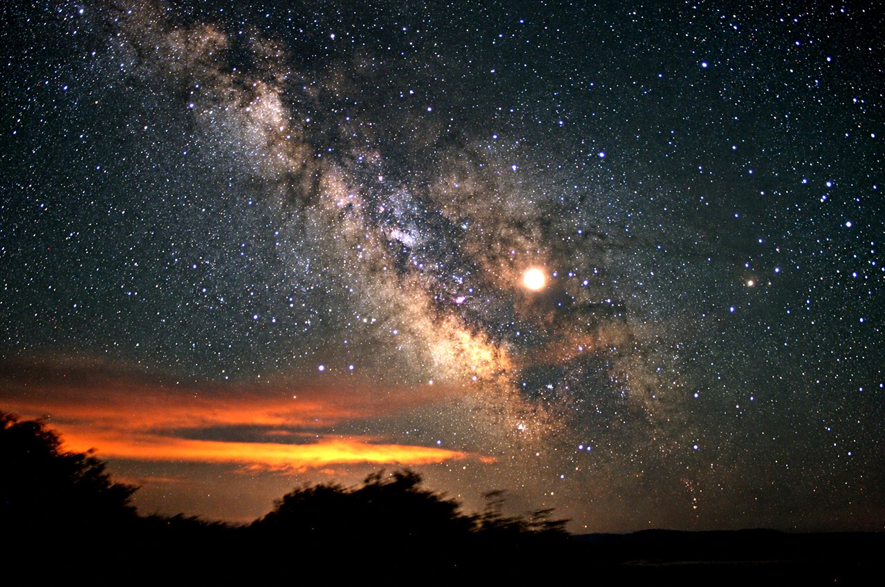 The Milky Way over a dark landscape