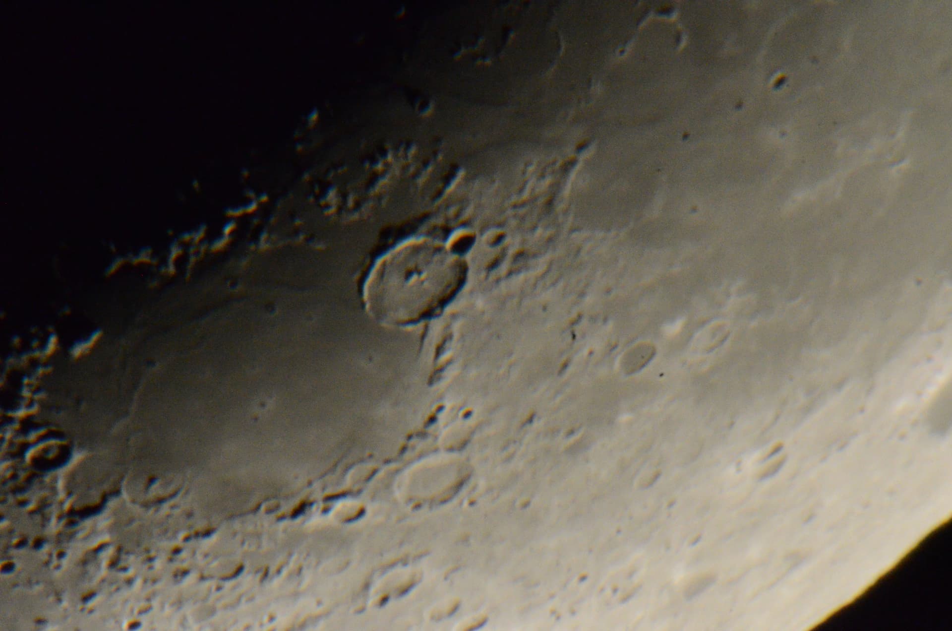Craters near the lunar limb under low sunlight