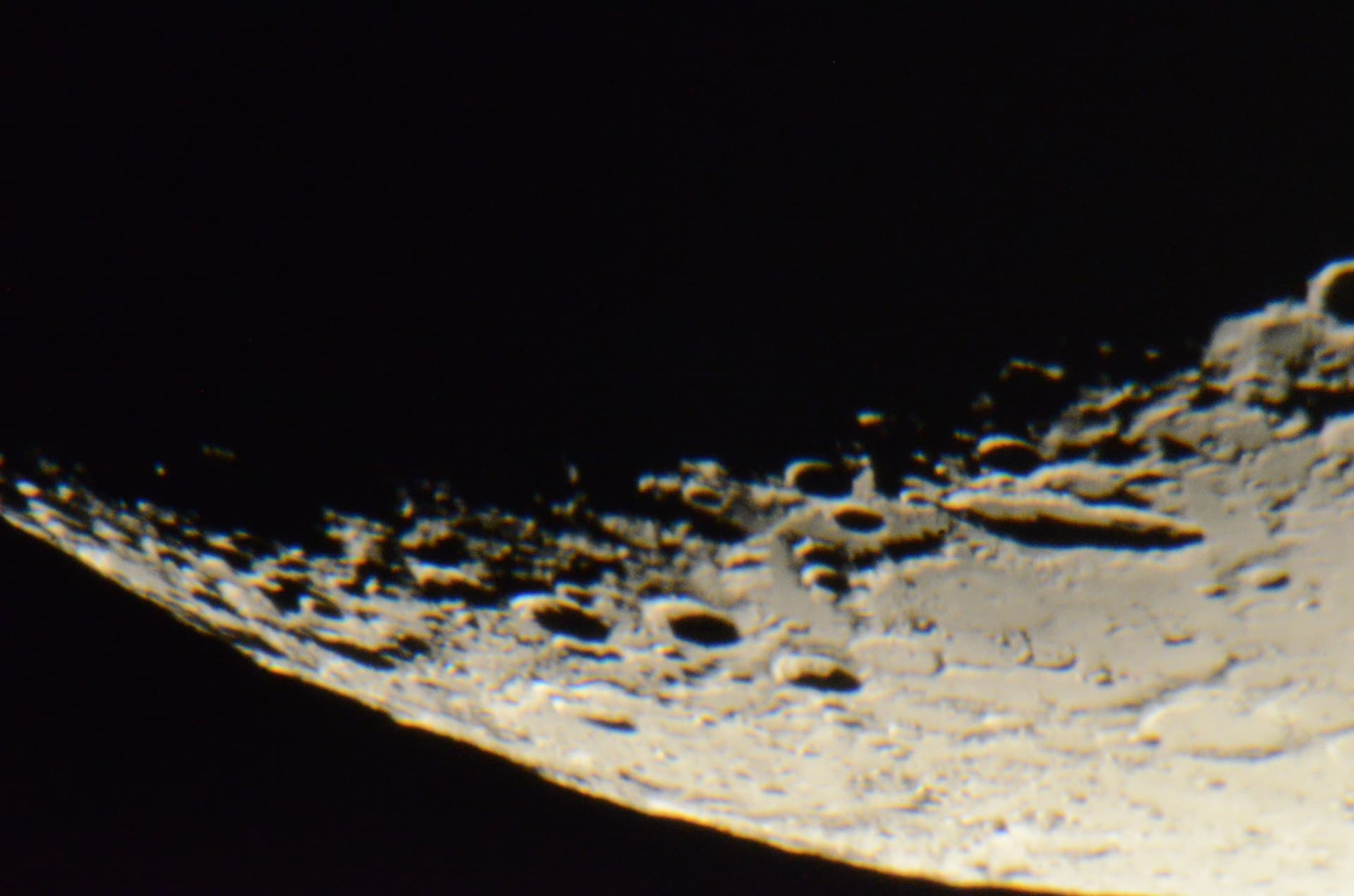 Close-up of the Moon's cratered surface near the limb